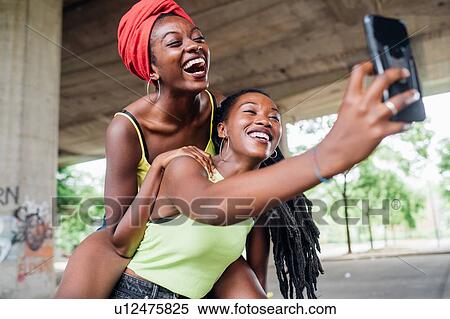 Friends taking selfie in city View Large Photo Image Stock Photography - Friends taking selfie in city. Fotosearch