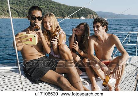 Friends taking selfie on sailboat, Italy View Large Photo Image Stock Image - Friends taking selfie on sailboat, Italy. Fotosearch
