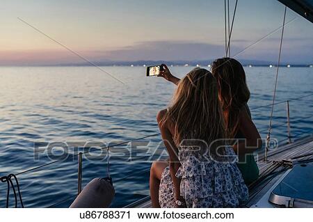 Friends taking selfie on sailboat, Italy View Large Photo Image Stock Image - Friends taking selfie on sailboat, Italy. Fotosearch