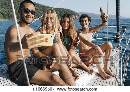 Friends taking selfie on sailboat, Italy View Large Photo Image Stock Photo - Friends taking selfie on sailboat, Italy. Fotosearch