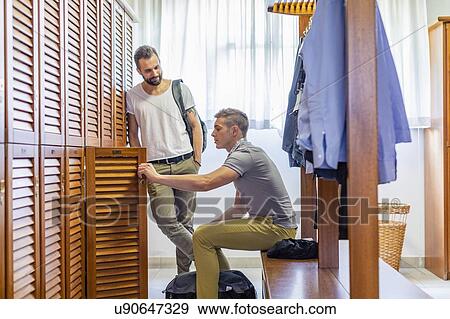 Friends talking in locker room View Large Photo Image Stock Photo - Friends talking in locker room. Fotosearch