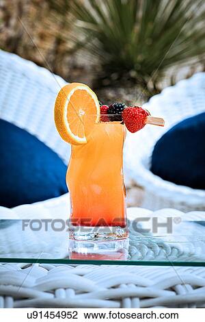 Stock Image - Fruit punch on glass table top. Fotosearch