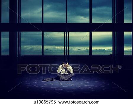 Stock Photography - Frustrated Businessman in Dark Room. Fotosearch