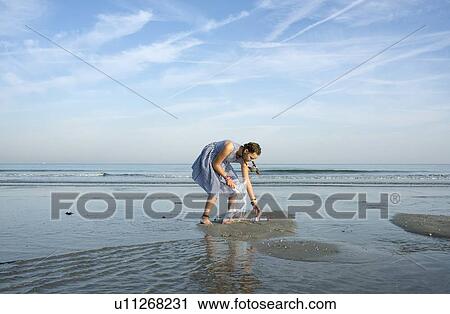 Girl collects plastic waste from beach, Hoek van Holland, Netherlands View Large Photo Image Stock Image - Girl collects plastic waste from beach, Hoek van Holland, Netherlands. Fotosearch