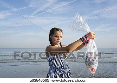 Girl collects plastic waste from beach, Hoek van Holland, Netherlands View Large Photo Image Stock Photography - Girl collects plastic waste from beach, Hoek van Holland, Netherlands. Fotosearch