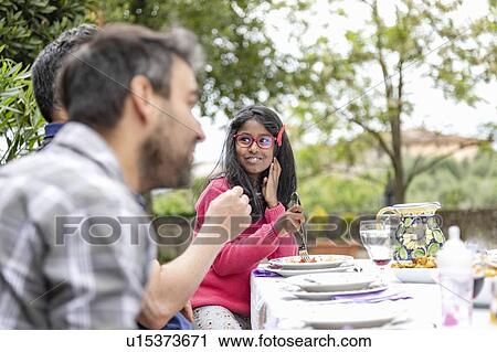 Girl listening to conversation at outdoor family lunch, Florence, Italy View Large Photo Image Stock Image - Girl listening to conversation at outdoor family lunch, Florence, Italy. Fotosearch