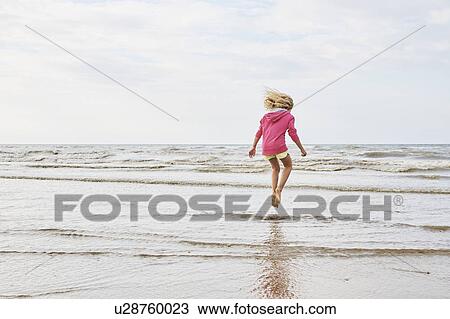 Girl playing on beach View Large Photo Image Stock Image - Girl playing on beach. Fotosearch