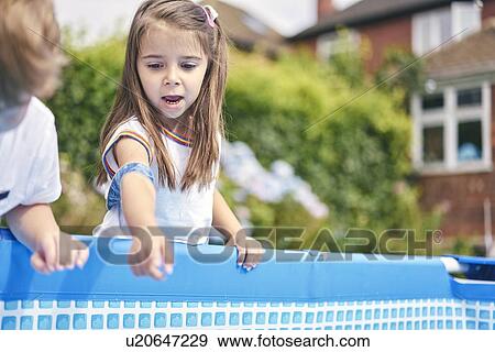 Girl pointing into pool View Large Photo Image Stock Photo - Girl pointing into pool. Fotosearch
