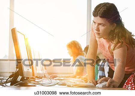Stock Photo - Girl using computer at school. Fotosearch