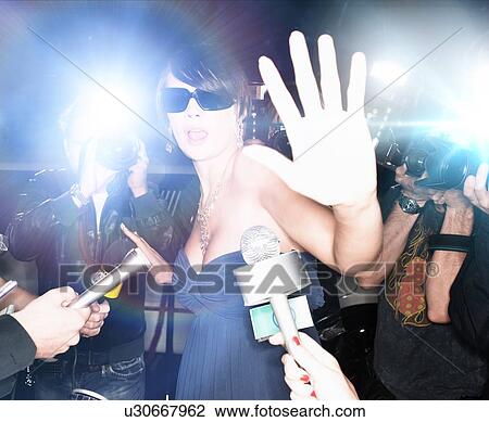 Stock Image - Glamourous Woman Surrounded by Paparazzi. Fotosearch