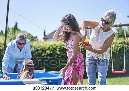 Grandmother putting sun lotion on granddaughter View Large Photo Image Stock Photo - Grandmother putting sun lotion on granddaughter. Fotosearch