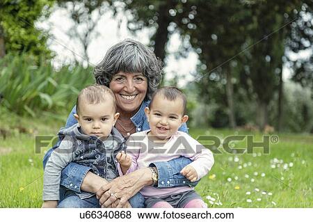 Grandmother with two grandchildren on lap in garden, Florence, Italy View Large Photo Image Stock Photo - Grandmother with two grandchildren on lap in garden, Florence, Italy. Fotosearch