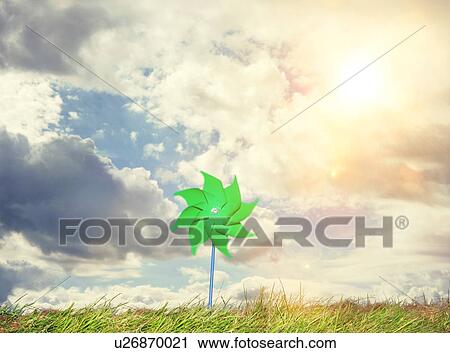 Green windmill toy on grass on summer day View Large Photo Image Stock Image - Green windmill toy on grass on summer day. Fotosearch