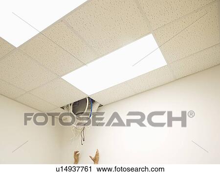Hands reaching towards cable hanging from hole in ceiling View Large Photo Image Stock Image - Hands reaching towards cable hanging from hole in ceiling. Fotosearch