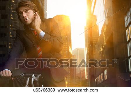 Handsome brunette business man commuting to work by bicycle wearing suit and tie View Large Photo Image Stock Photo - Handsome brunette business man commuting to work by bicycle wearing suit and tie. Fotosearch
