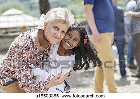 Happy girl hugging senior woman at family gathering, Florence, Italy View Large Photo Image Stock Photography - Happy girl hugging senior woman at family gathering, Florence, Italy. Fotosearch