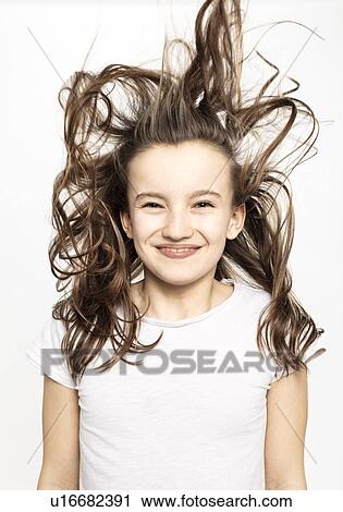 Happy girl with flying hair, white background View Large Photo Image Stock Image - Happy girl with flying hair, white background. Fotosearch