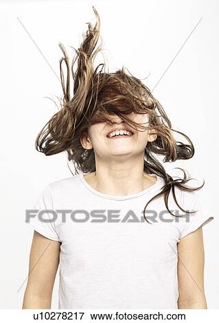 Stock Photo - Happy girl with flying hair, white background. Fotosearch