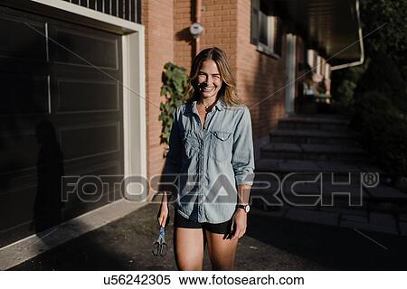 Happy woman gardener out in garden at night View Large Photo Image Stock Photography - Happy woman gardener out in garden at night. Fotosearch