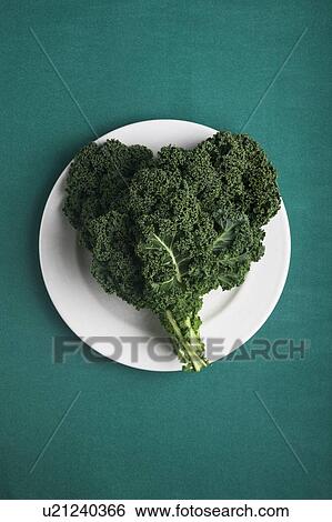 Stock Photograph - Heart shaped kale leaves on a plate. Fotosearch