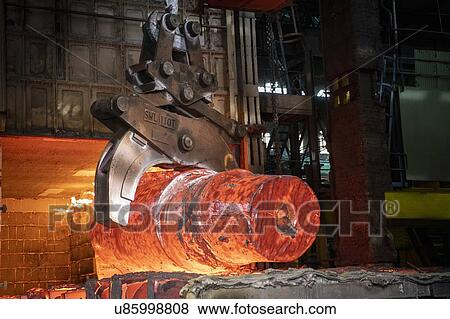 Heat treated red hot steel ingot being lifted by crane in furnace in steelworks View Large Photo Image Stock Photo - Heat treated red hot steel ingot being lifted by crane in furnace in steelworks. Fotosearch