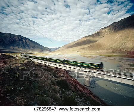 Stock Photo - High Speed Train Traveling Through Valley. Fotosearch