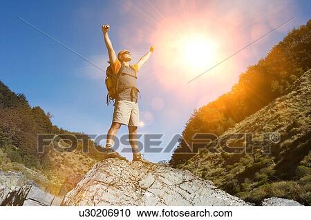 Hiker celebrating summer hike outdoors View Large Photo Image Stock Image - Hiker celebrating summer hike outdoors. Fotosearch