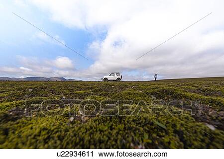 Hiker exploring mossy landscape, Landmannalaugar, Highlands, Iceland View Large Photo Image Stock Image - Hiker exploring mossy landscape, Landmannalaugar, Highlands, Iceland. Fotosearch