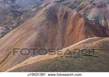 Hiker exploring mountains, Brennisteinsalda and Blhnjkur, Landmannalaugar, Highlands, Iceland View Large Photo Image Stock Image - Hiker exploring mountains, Brennisteinsalda and Blhnjkur, Landmannalaugar, Highlands, Iceland. Fotosearch
