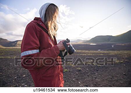 Picture - Hiker looking at camera, Landmannalaugar, Highlands, Iceland. Fotosearch