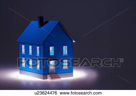 Stock Photograph - Illuminated little blue model house. Fotosearch