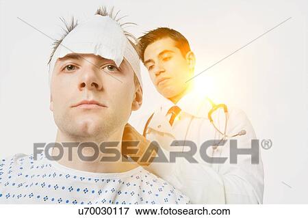 Stock Photo - Indian male doctor treating male patient. Fotosearch