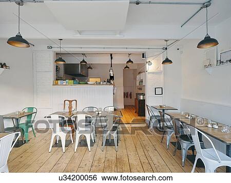 Interior of restaurant, furnished with tables, chairs, ceiling lamps View Large Photo Image Stock Photograph - Interior of restaurant, furnished with tables, chairs, ceiling lamps. Fotosearch