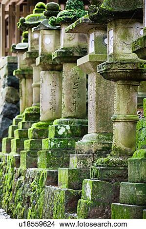 Picture - Japan Mara Row of stone lanterns in garden. Fotosearch