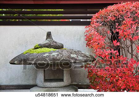 Stock Image - Japan Takayama Stone Lantern and bush in Autumn colors. Fotosearch