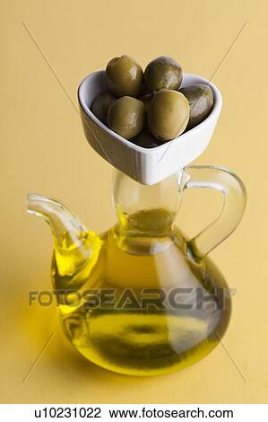 Jug of olive oil with olives in heart shaped dish View Large Photo Image Stock Image - Jug of olive oil with olives in heart shaped dish. Fotosearch