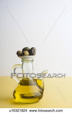 Jug of olive oil with olives View Large Photo Image Picture - Jug of olive oil with olives. Fotosearch