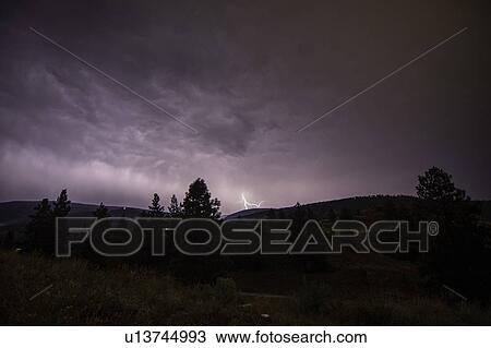 Stock Image - Lightning bolts during thunderstorm over Okanagan Valley, British Columbia, Canada. Fotosearch
