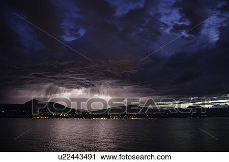 Stock Image - Lightning bolts during thunderstorm over Okanagan Valley, British Columbia, Canada. Fotosearch