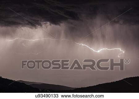 Stock Image - Lightning bolts during thunderstorm over Okanagan Valley, British Columbia, Canada. Fotosearch