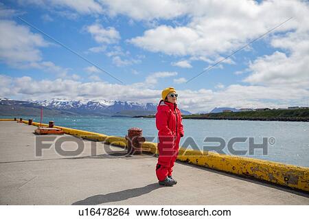 Little girl in snow suit waiting at harbor for boat, Dalvik, Iceland View Large Photo Image Picture - Little girl in snow suit waiting at harbor for boat, Dalvik, Iceland. Fotosearch