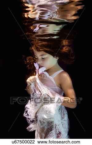 Stock Image - Little girl in underwater garden. Fotosearch