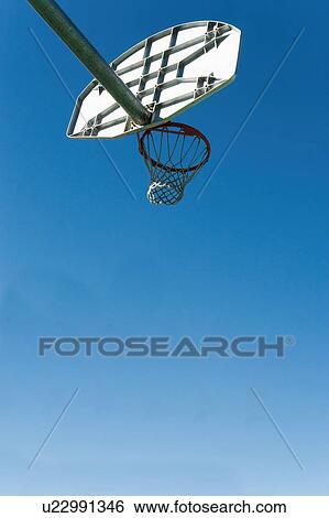 Stock Photograph - Low angled view of a basket ball net and hoop and backboard. Fotosearch
