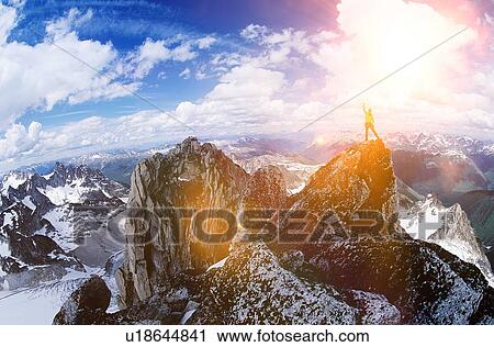 Male hiker celebrating at the top of the mountain against strong lens flare View Large Photo Image Stock Image - Male hiker celebrating at the top of the mountain against strong lens flare. Fotosearch