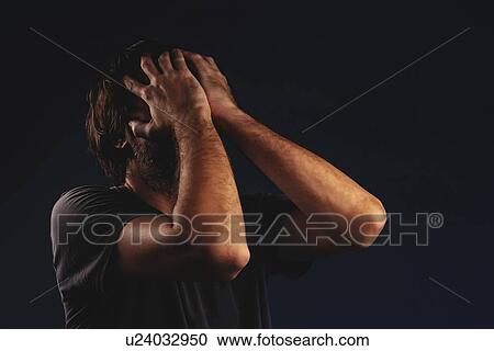 Stock Image - Man crying in despair. Fotosearch