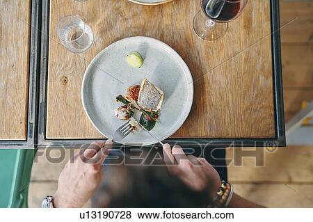 Man having meal in restaurant View Large Photo Image Stock Photo - Man having meal in restaurant. Fotosearch