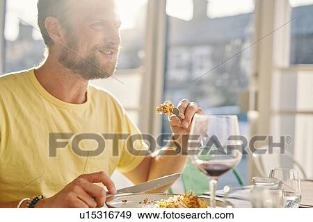 Stock Photo - Man having meal in restaurant. Fotosearch