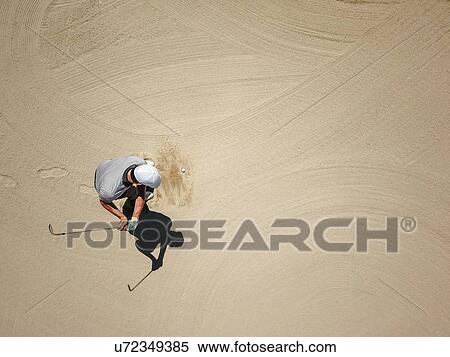 Stock Photography - Man playing golf on bunker. Fotosearch
