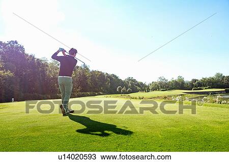 Man playing golf on golf course View Large Photo Image Stock Image - Man playing golf on golf course. Fotosearch