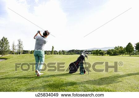 Man playing golf on golf course View Large Photo Image Stock Photo - Man playing golf on golf course. Fotosearch